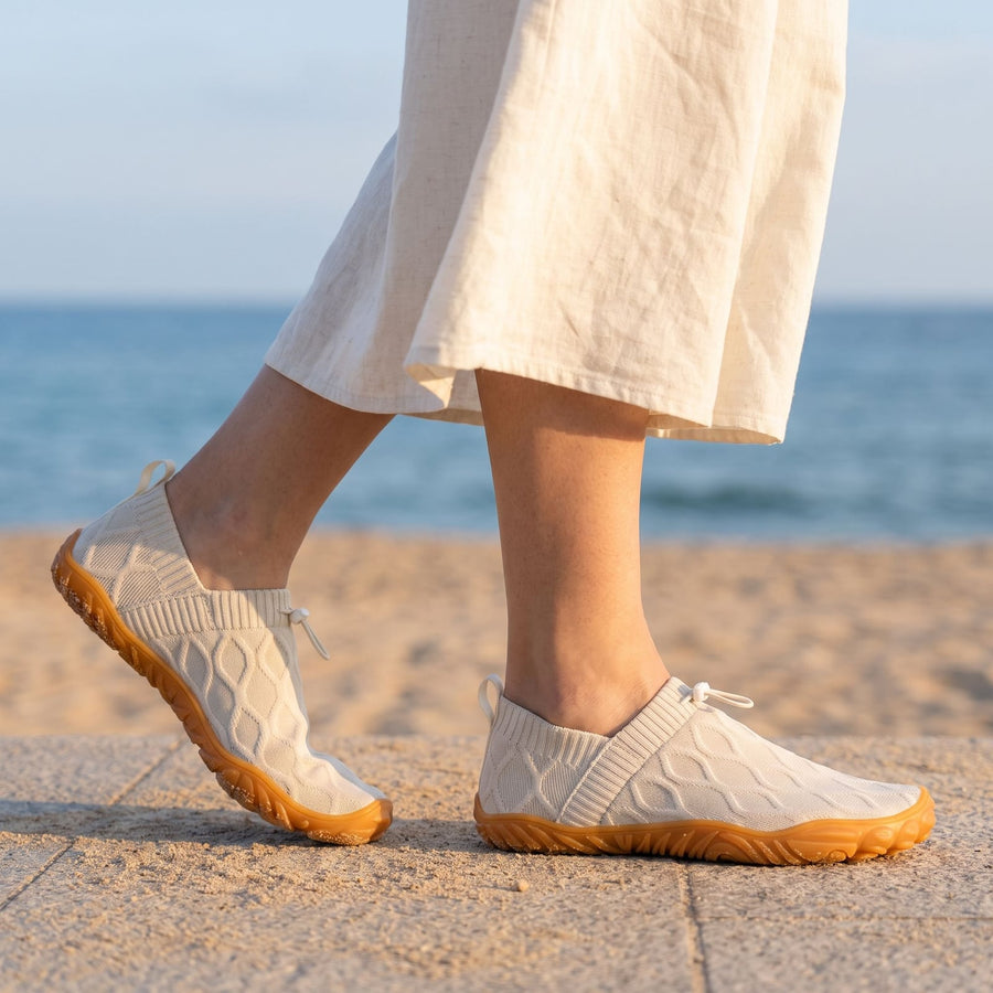 Off-white StrideFlex shoes on a seaside promenade